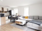 Wohnzimmer mit offenem Kochbereich - Schöne Erdgeschosswohnung mit Garten und Stellplatz in der Tiefgarage